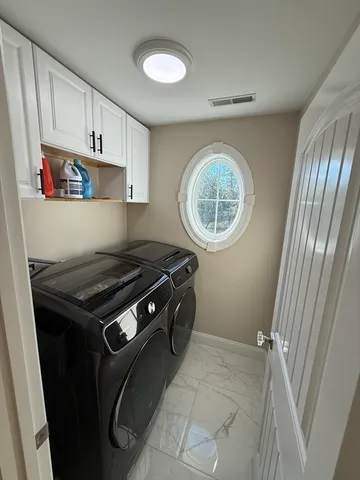 a kitchen with granite countertop a stove a sink and a refrigerator