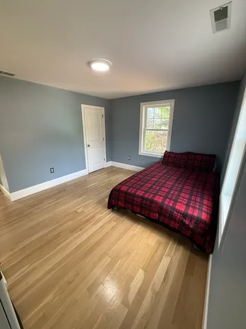 a bedroom with a bed and window