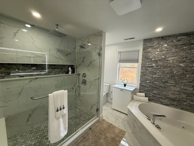 a bathroom with a granite countertop sink a toilet and bathtub