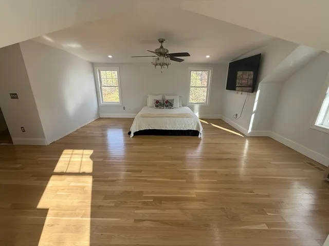 a view of a livingroom with furniture window and wooden floor