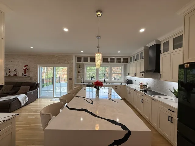 a kitchen with stainless steel appliances kitchen island granite countertop a sink and cabinets