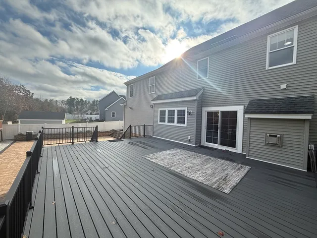 swimming pool view with a wooden floor and fence