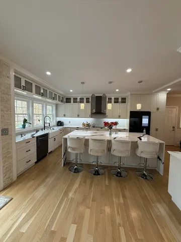 a large kitchen with a table and chairs in it