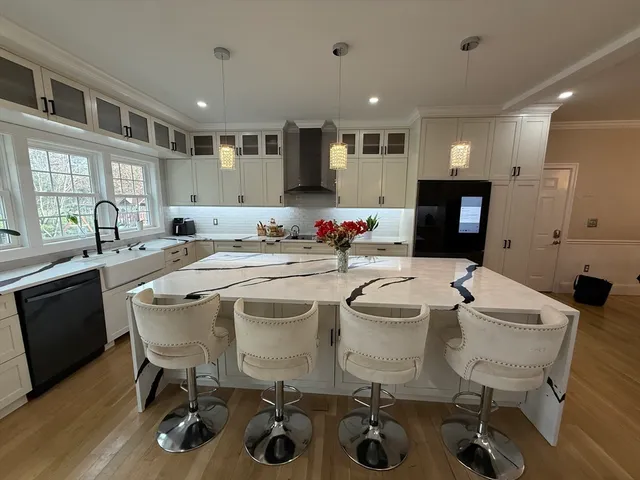 a kitchen with a sink a stove a dining table and chairs