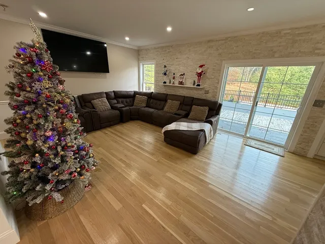a living room with furniture and a floor to ceiling window