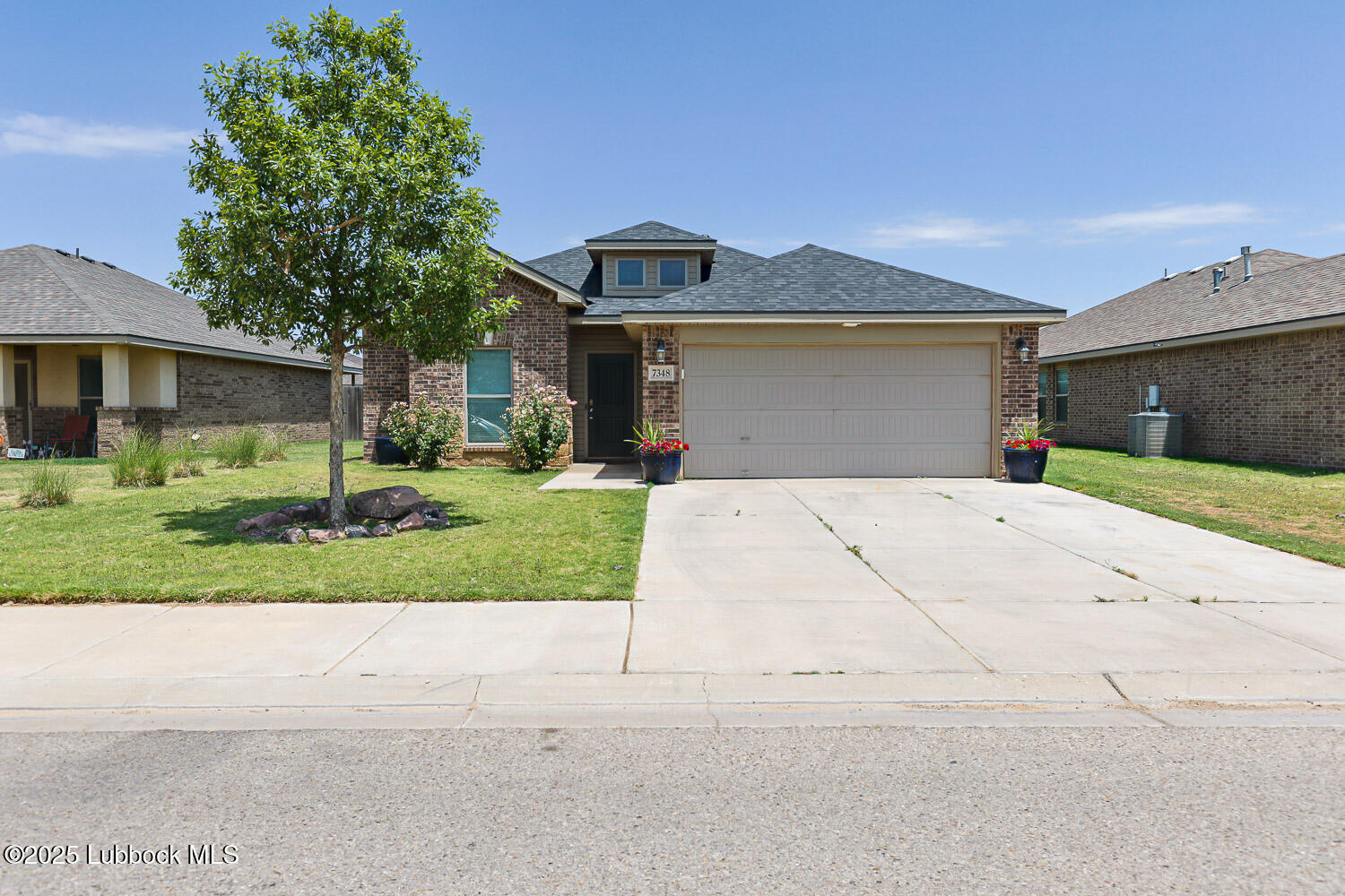7348 100th Street Lubbock, TX 79424 - Photo 1 of 55 front view of house with a yard