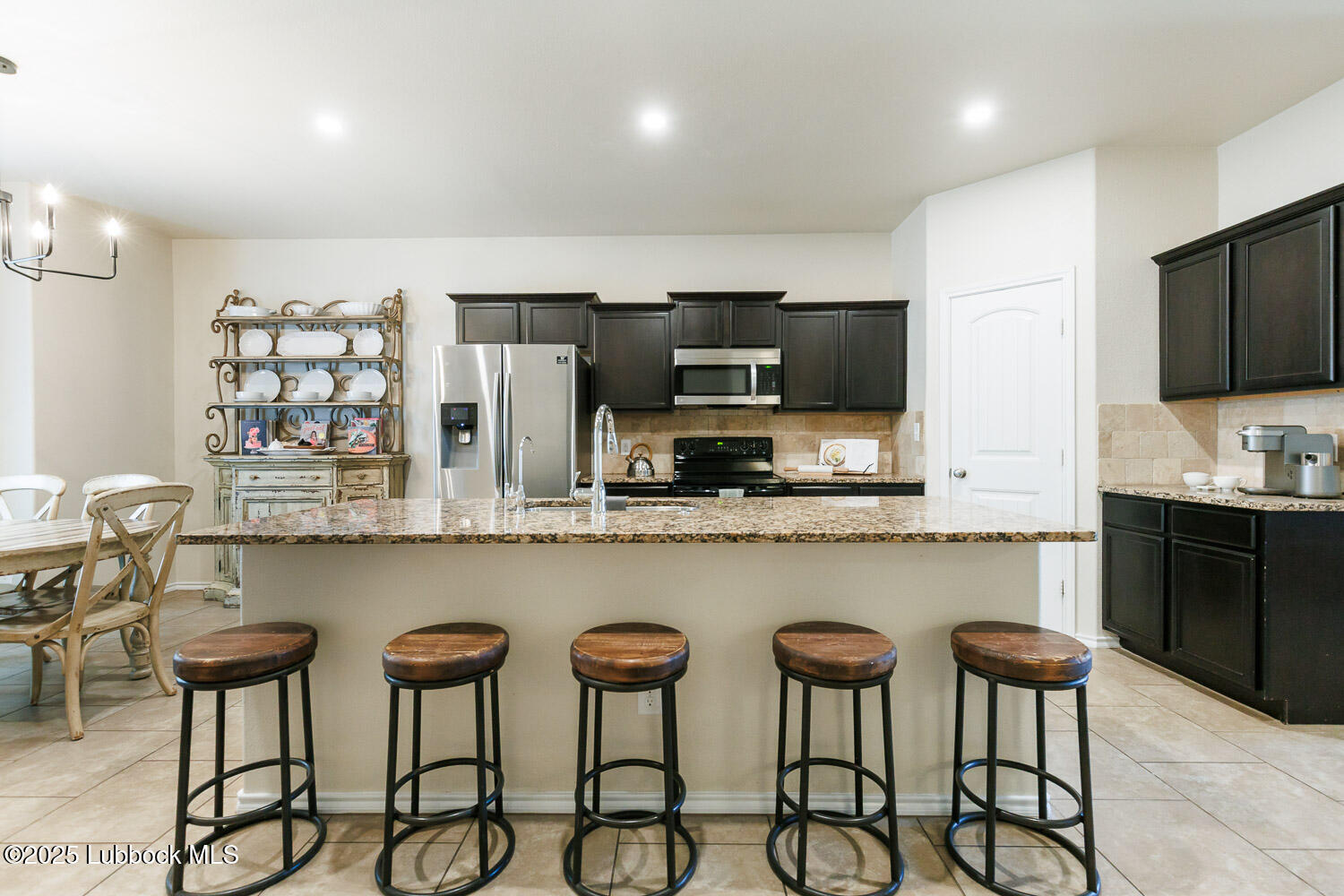 7348 100th Street Lubbock, TX 79424 - Photo 12 of 55 a kitchen with stainless steel appliances granite countertop a stove a sink and a refrigerator
