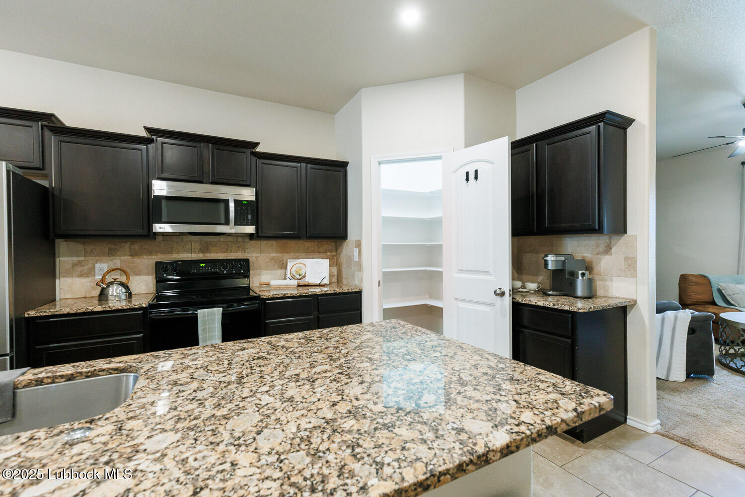 7348 100th Street Lubbock, TX 79424 - Photo 14 of 55 a kitchen with a sink stove and refrigerator