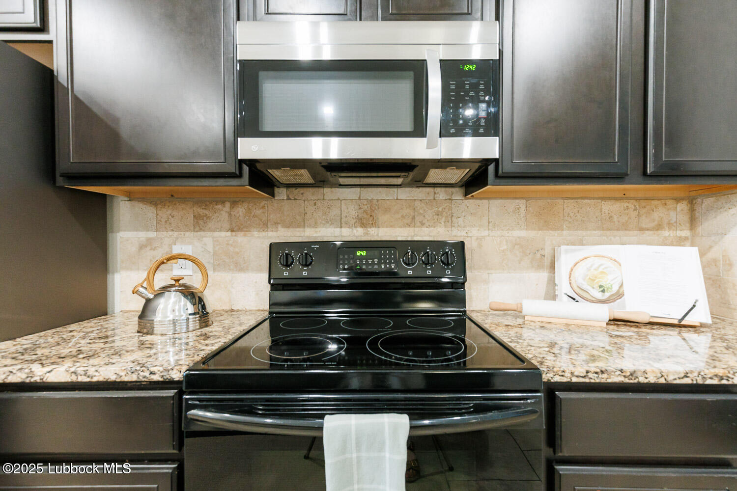 7348 100th Street Lubbock, TX 79424 - Photo 19 of 55 a stove top oven sitting inside of a kitchen