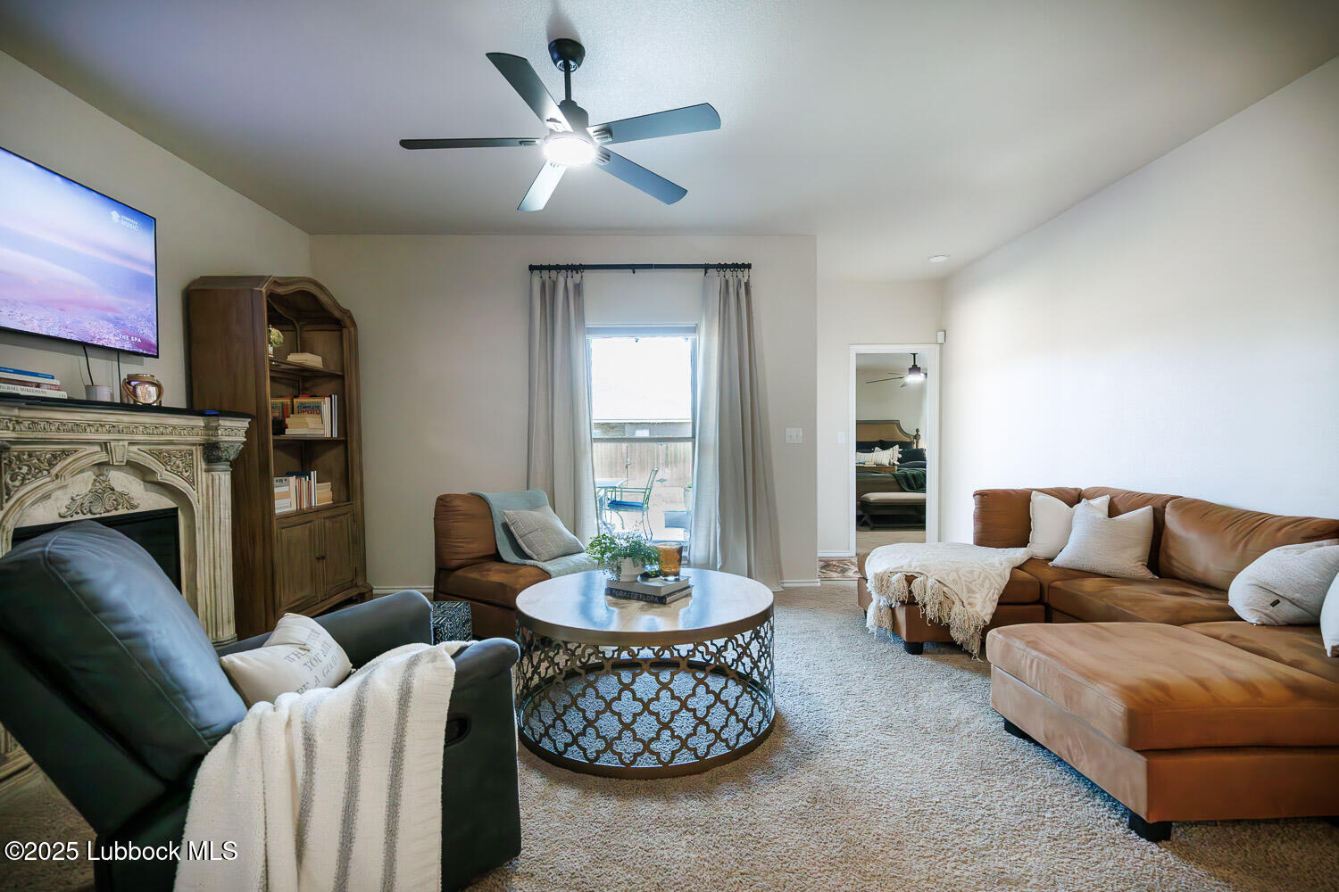7348 100th Street Lubbock, TX 79424 - Photo 22 of 55 a living room with furniture a fireplace and a flat screen tv