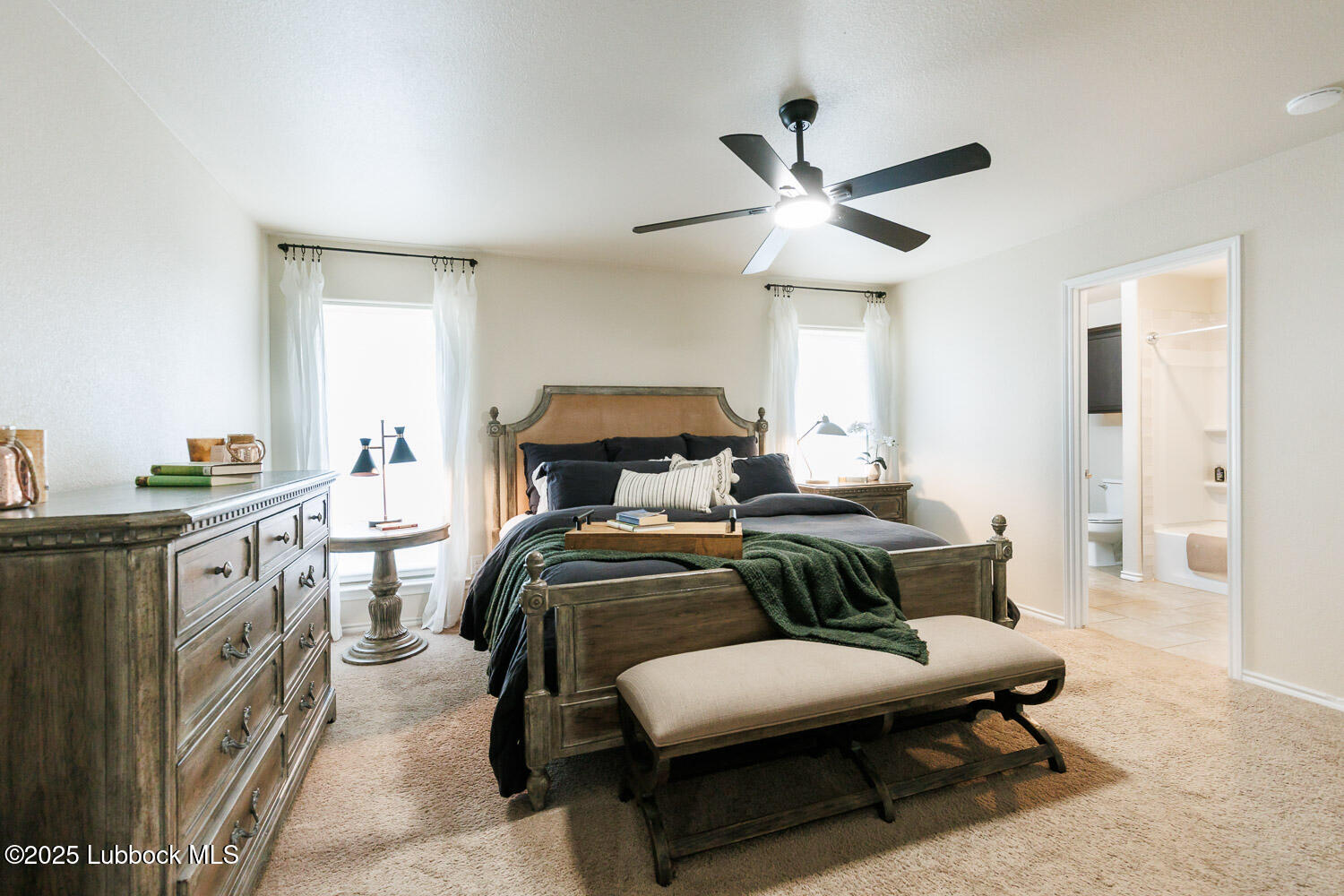 7348 100th Street Lubbock, TX 79424 - Photo 26 of 55 a bedroom with furniture and a chandelier