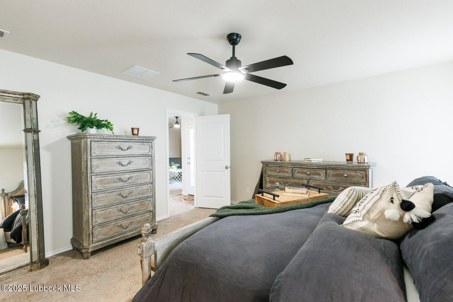 7348 100th Street Lubbock, TX 79424 - Photo 27 of 55 a bed room with a bed and a ceiling fan