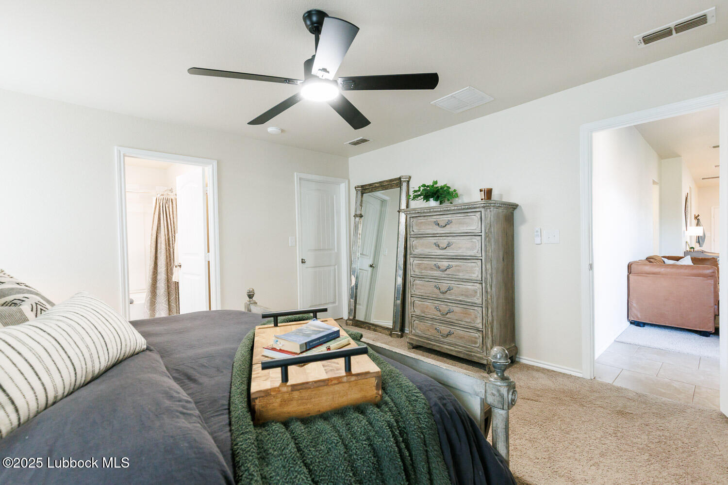 7348 100th Street Lubbock, TX 79424 - Photo 28 of 55 a bedroom with furniture and a chandelier
