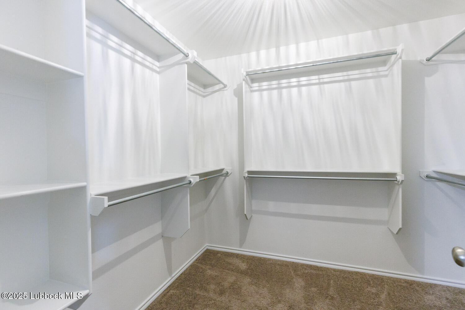 7348 100th Street Lubbock, TX 79424 - Photo 31 of 55 a view of walk in closet with empty racks