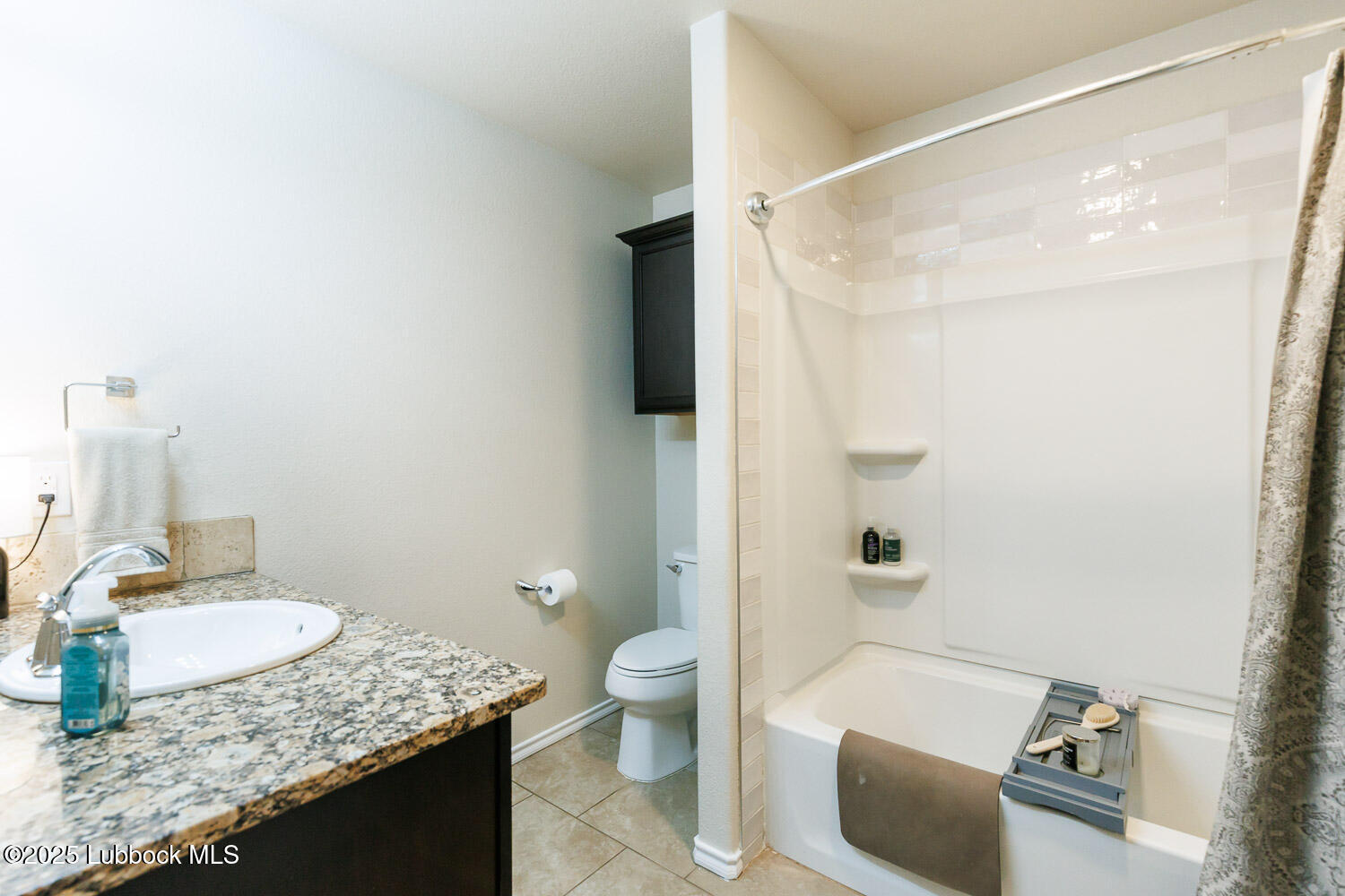 7348 100th Street Lubbock, TX 79424 - Photo 32 of 55 a bathroom with a granite countertop sink and a mirror