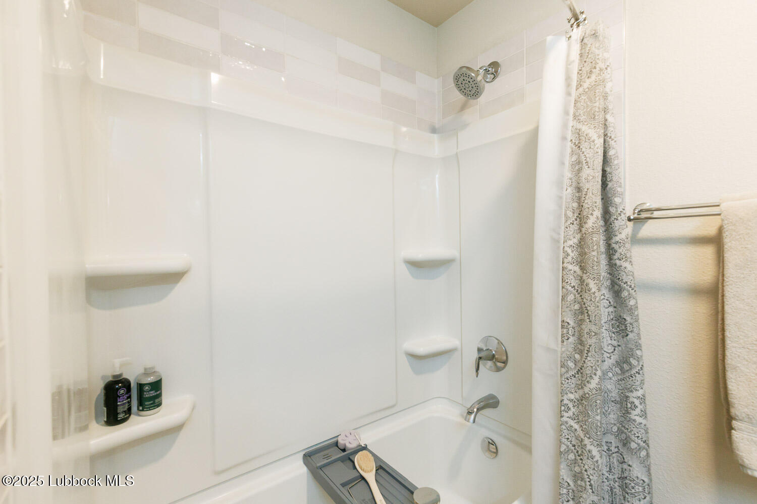 7348 100th Street Lubbock, TX 79424 - Photo 33 of 55 a bathroom with a bathtub and shower