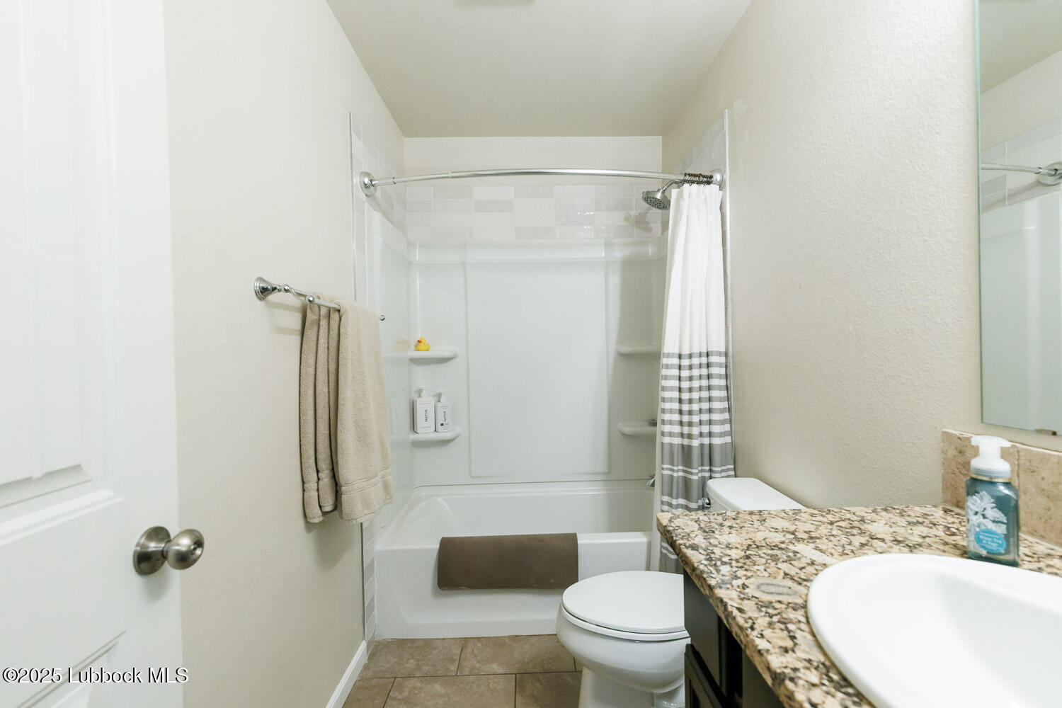 7348 100th Street Lubbock, TX 79424 - Photo 37 of 55 a bathroom with a granite countertop toilet sink and shower