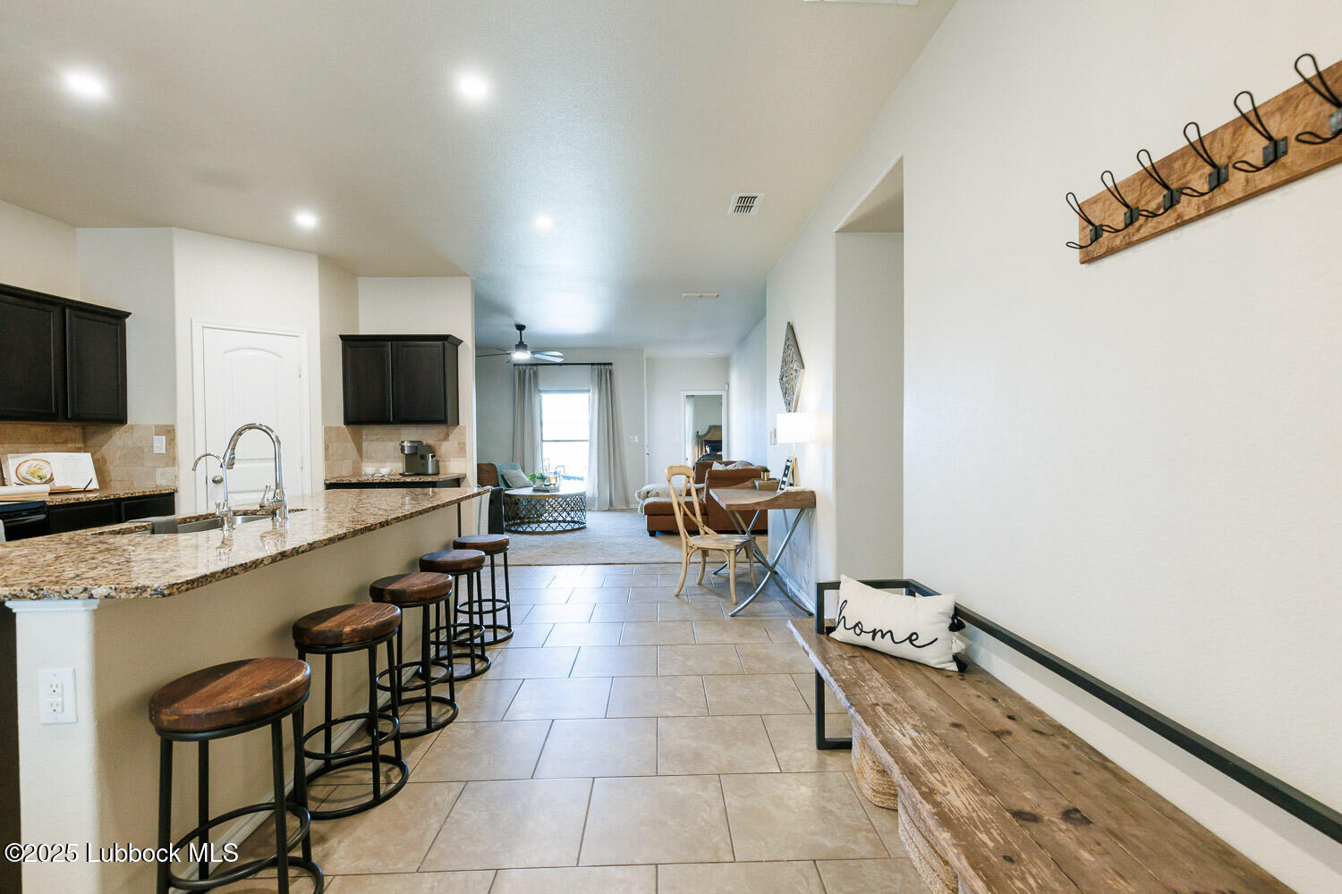 7348 100th Street Lubbock, TX 79424 - Photo 6 of 55 a large white kitchen with a sink and a stove top open