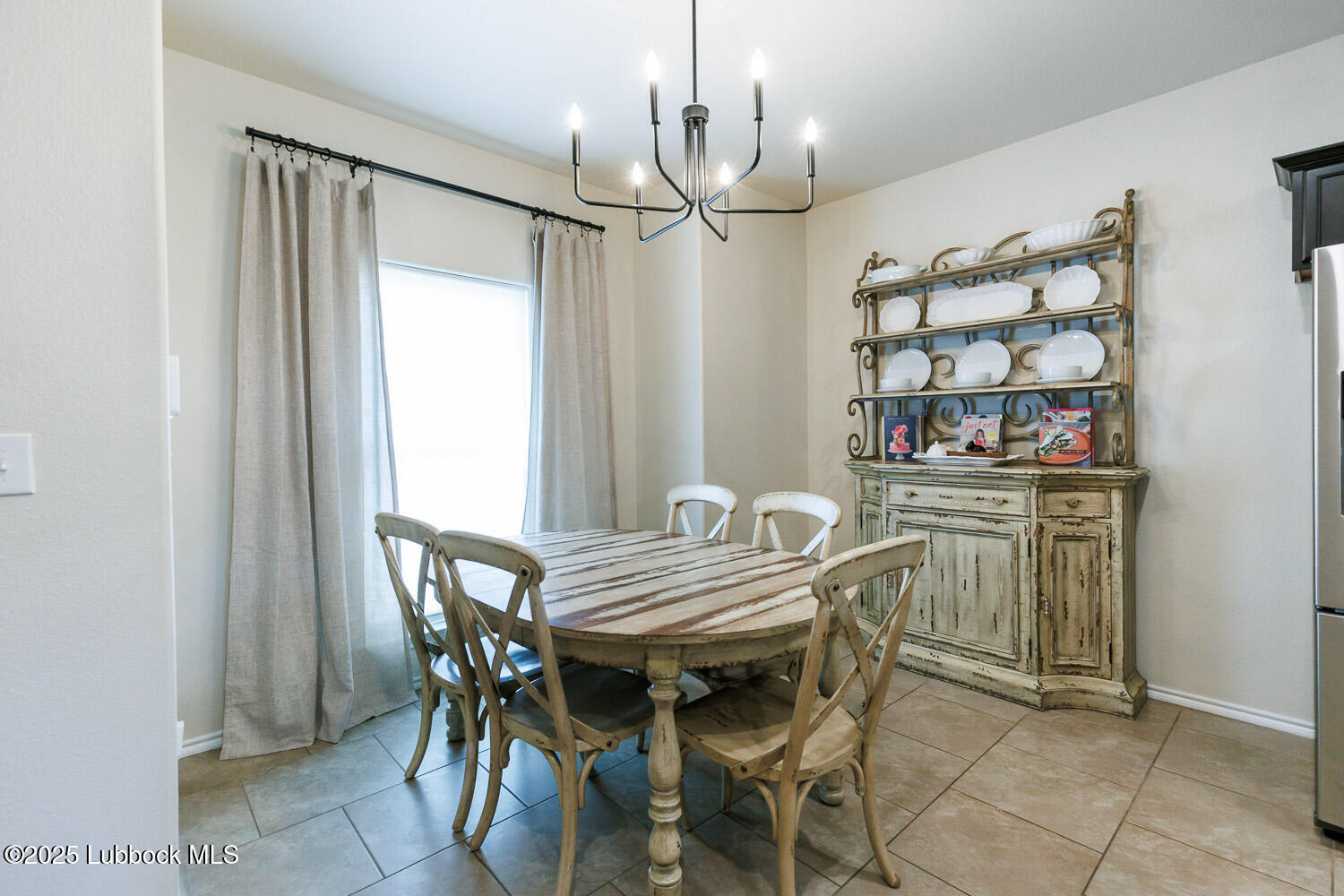 7348 100th Street Lubbock, TX 79424 - Photo 8 of 55 a view of a dining room with furniture and chandelier