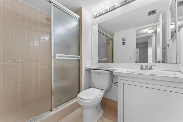 a bathroom with a toilet sink and shower