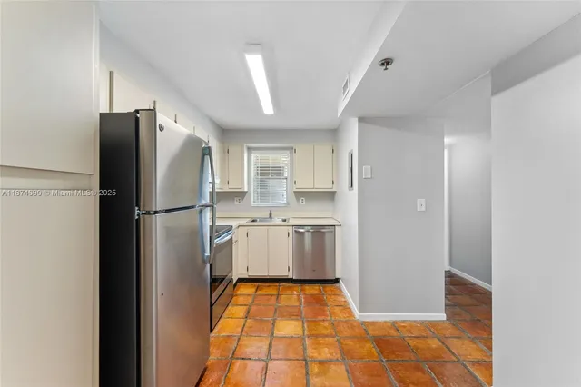 a kitchen with a refrigerator and a sink