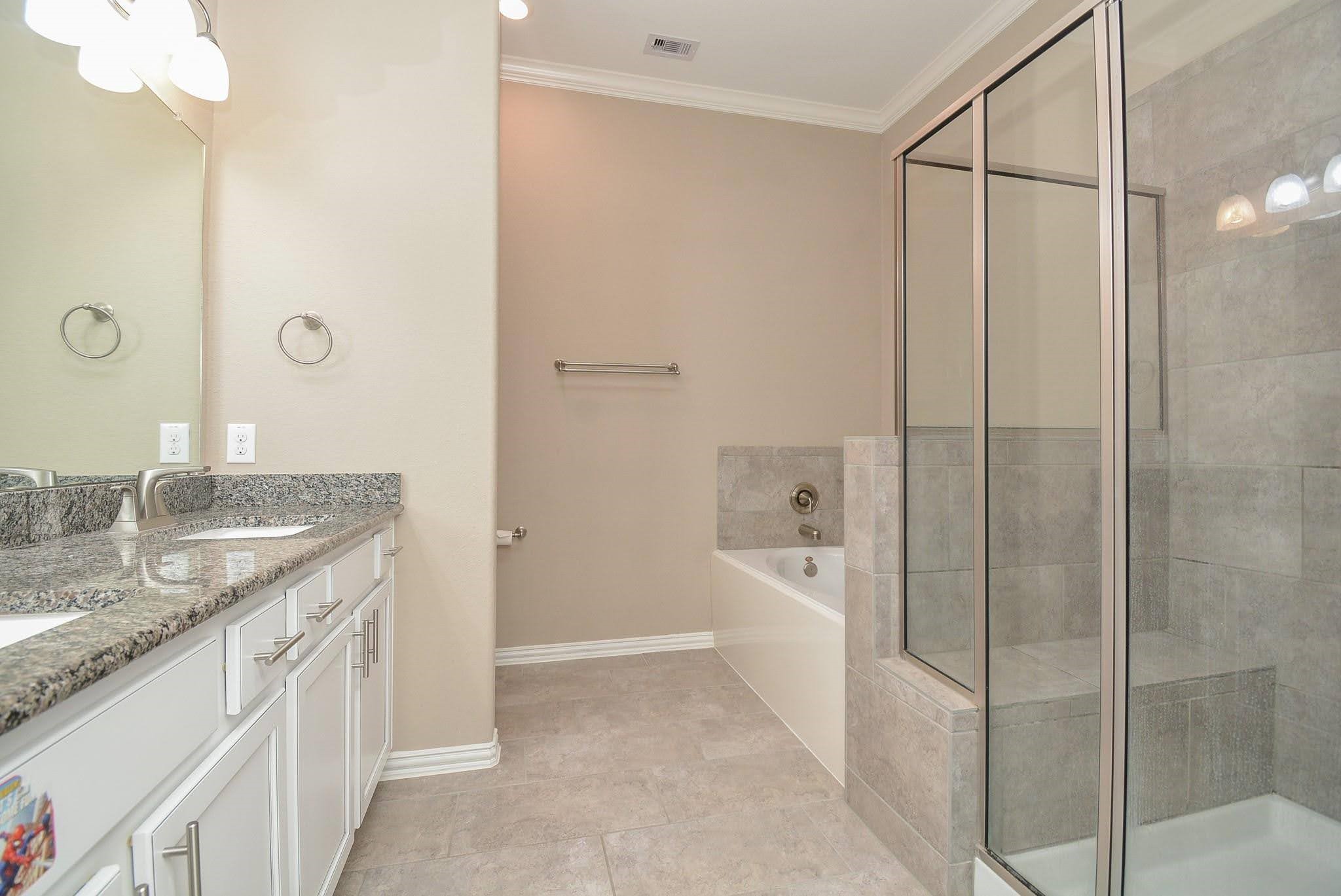 20414 Duncan Run Lane Cypress, TX 77433 - Photo 14 of 18 a bathroom with a granite countertop sink a toilet and shower