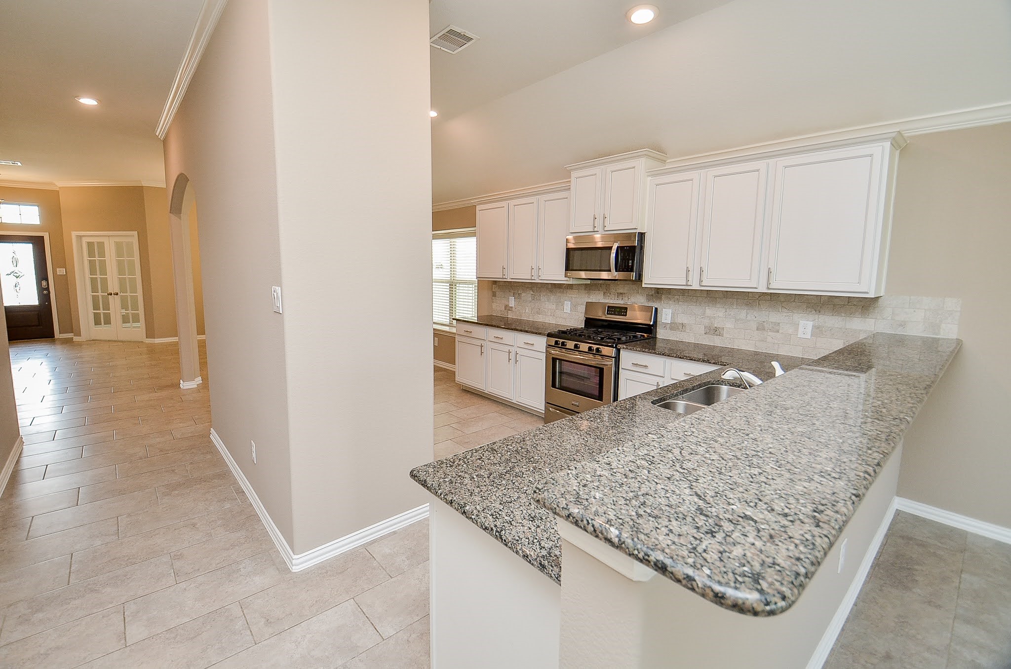 20414 Duncan Run Lane Cypress, TX 77433 - Photo 7 of 18 a kitchen with stainless steel appliances granite countertop a sink stove and refrigerator