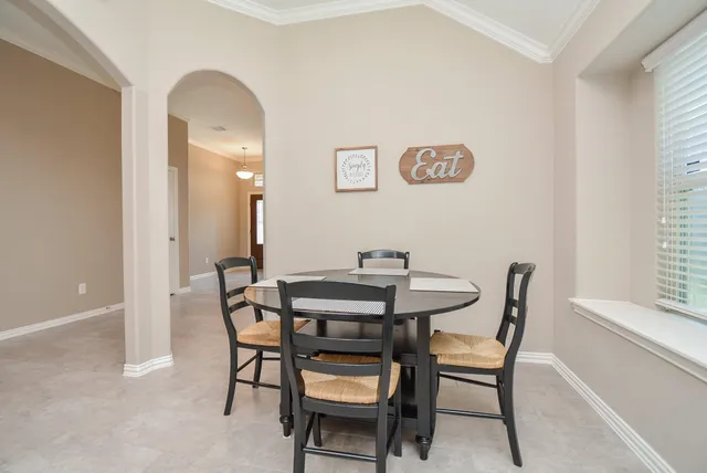 a kitchen with stainless steel appliances granite countertop a stove a microwave a sink and white cabinets