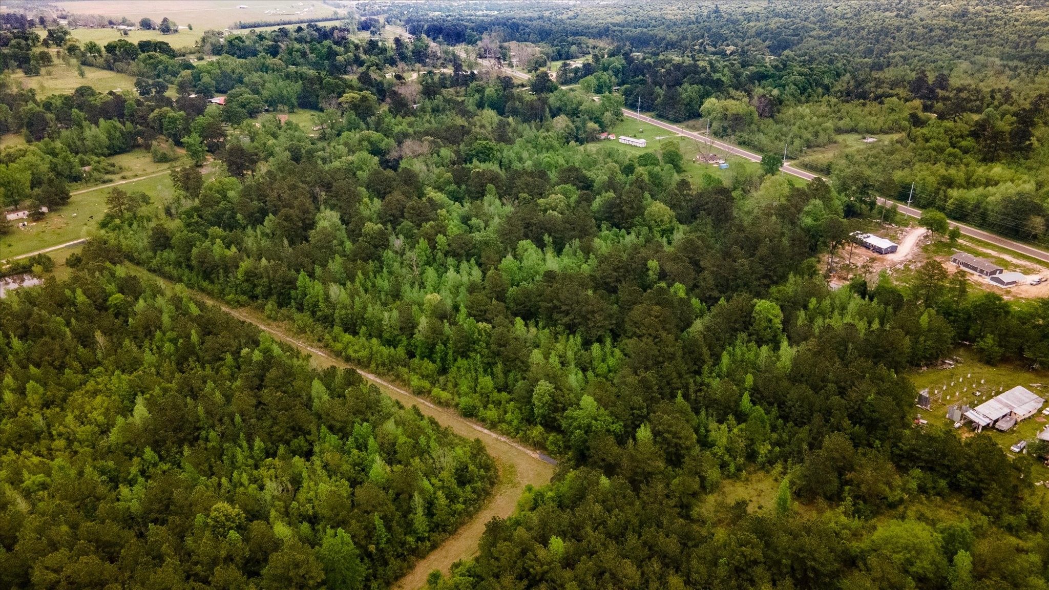 Tbd Shaw Road Hull, TX 77564 - Photo 17 of 31 an aerial view of a house with a lush green forest