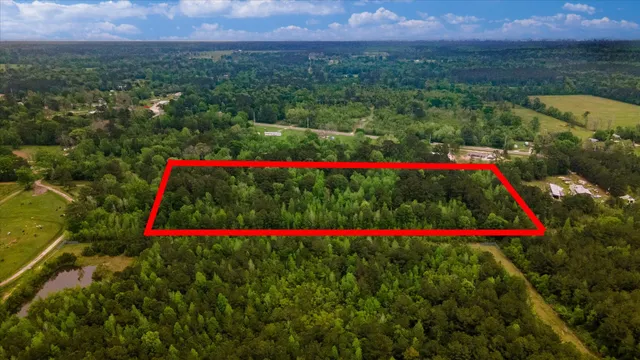an aerial view of a houses and a yard