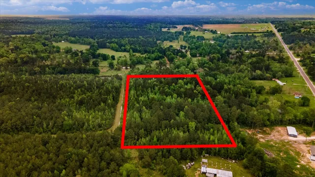 an aerial view of a yard and mountain view in back
