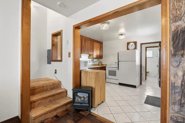 a kitchen with a refrigerator sink and cabinets