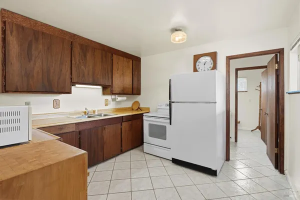 a kitchen with stainless steel appliances a stove a sink and a refrigerator