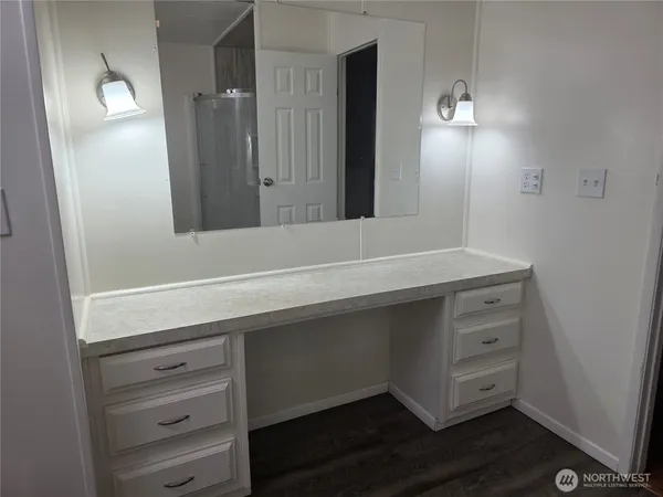 a bathroom with a sink vanity and mirror