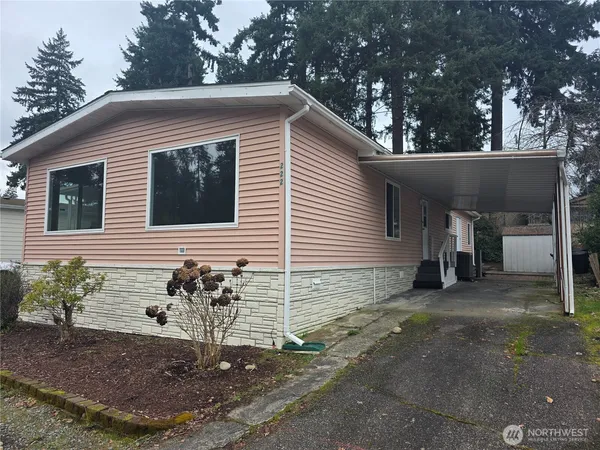 a view of a house with a yard and garage
