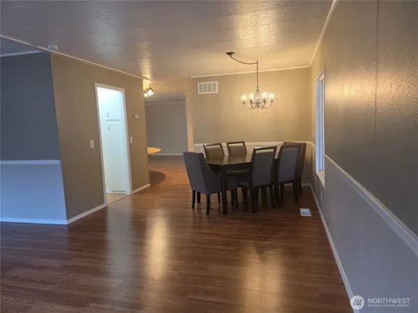 a view of a dining room with furniture and wooden floor