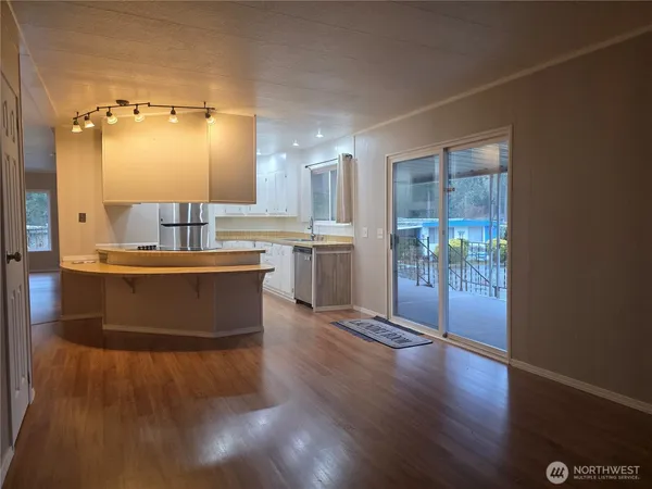 a large kitchen with a large counter top space and stainless steel appliances