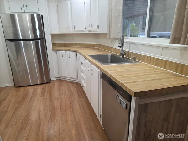 a kitchen with a sink and refrigerator