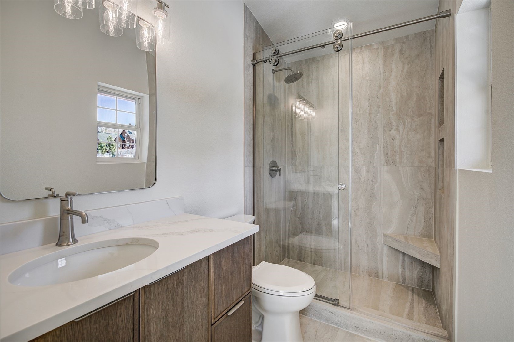 22 North Side Circle Silverthorne, CO 80498 - Photo 4 of 28 a bathroom with a shower sink vanity mirror and toilet