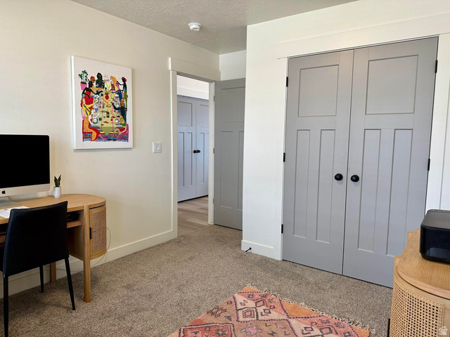 4349 Half Mile Road East Enoch, UT 84721 - Photo 20 of 36 Office area with light colored carpet and a textured ceiling