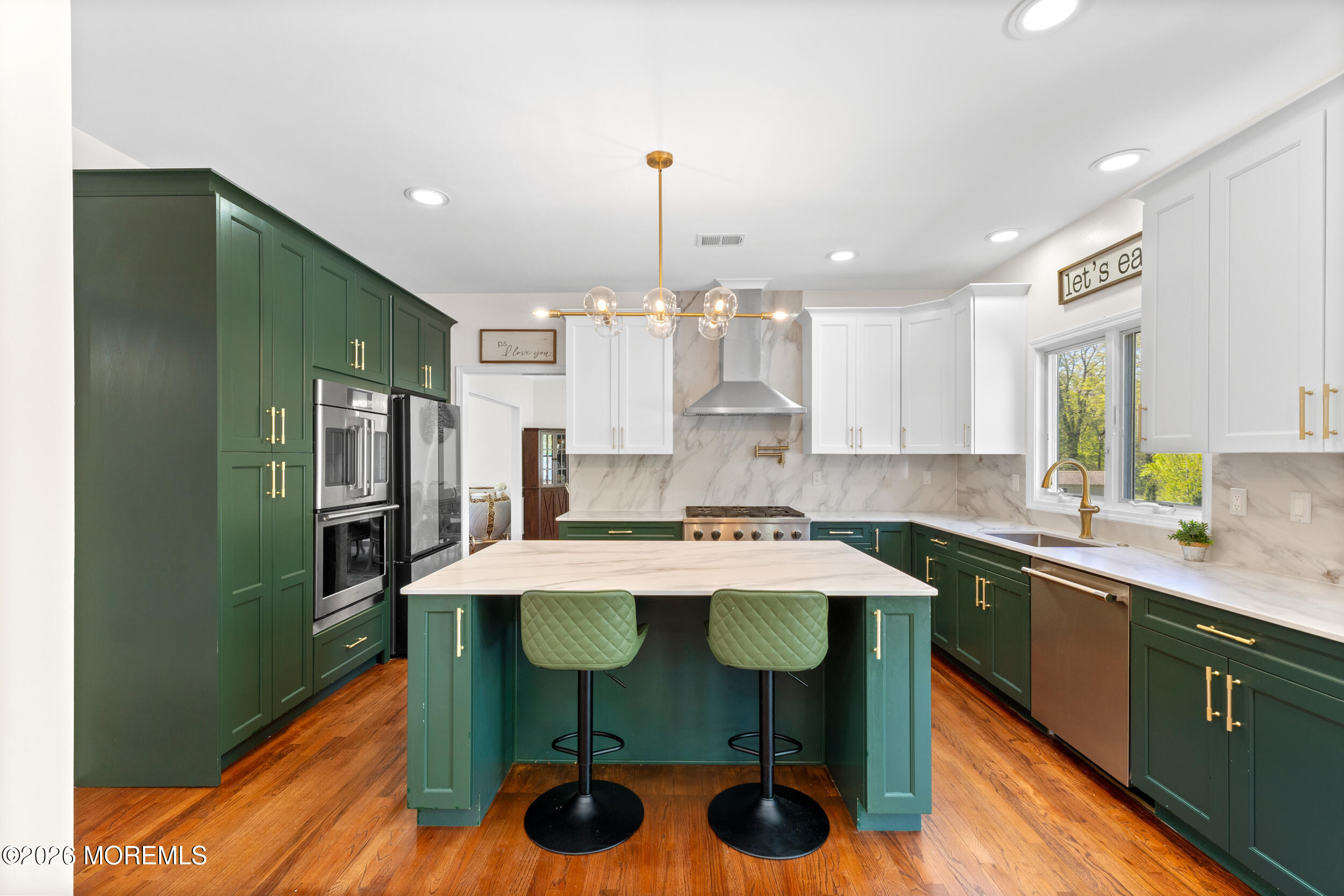 104 Autumn Road Matawan, NJ 07747 - Photo 14 of 64 a kitchen with stainless steel appliances a table chairs refrigerator and sink