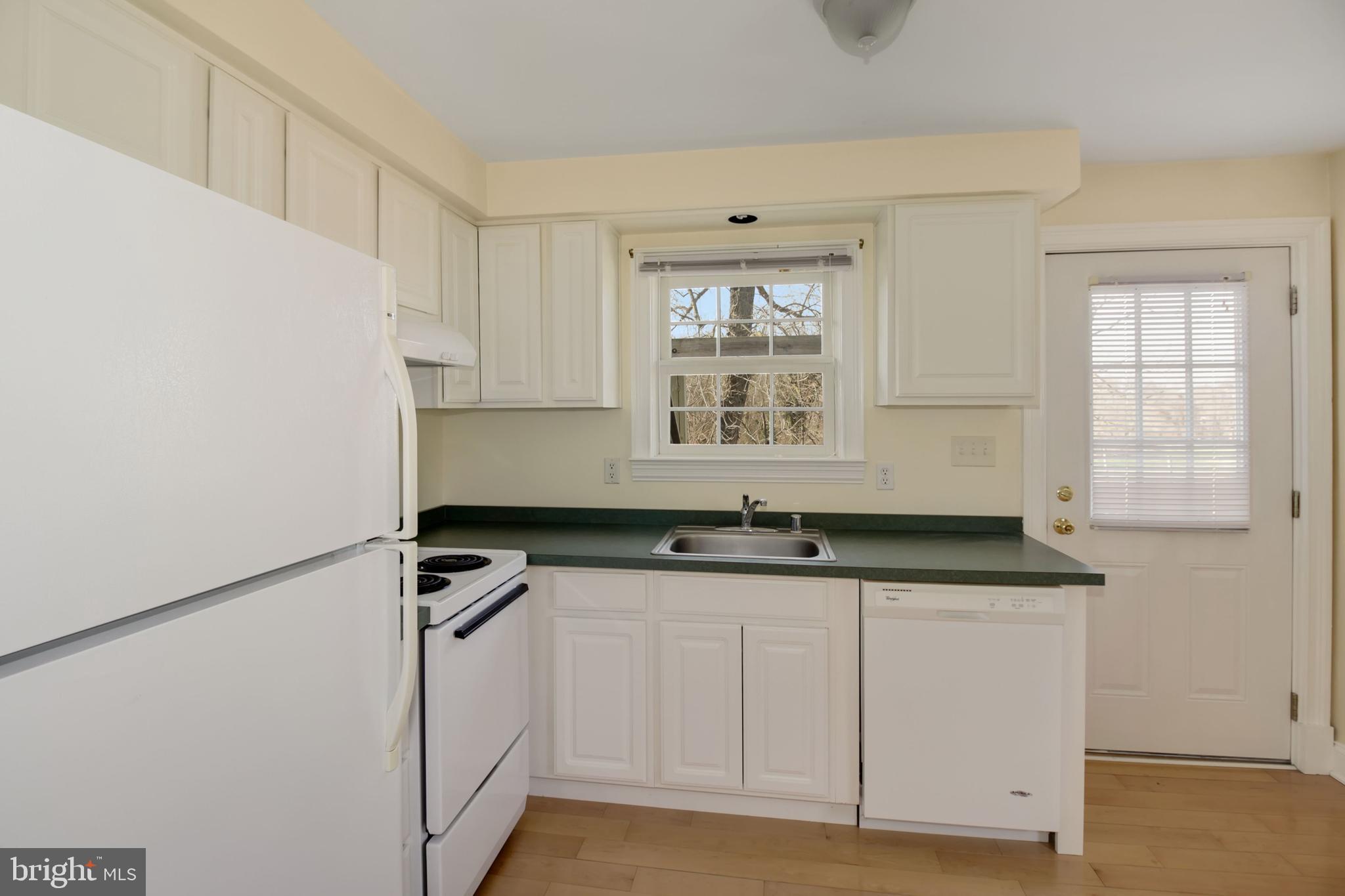 112 Main Street, Unit A New Windsor, MD 21776 - Photo 11 of 39 a kitchen with granite countertop a sink and a refrigerator