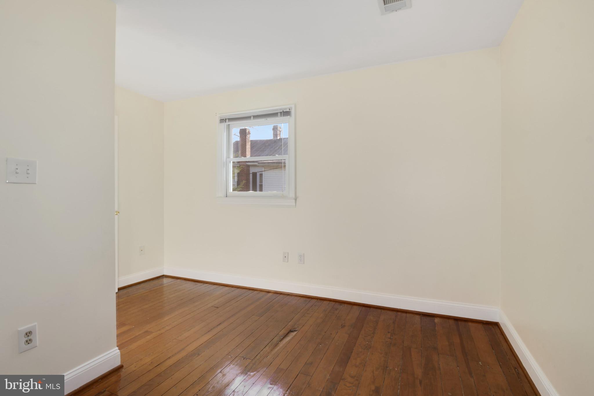 112 Main Street, Unit A New Windsor, MD 21776 - Photo 14 of 39 a view of an empty room with wooden floor and a window