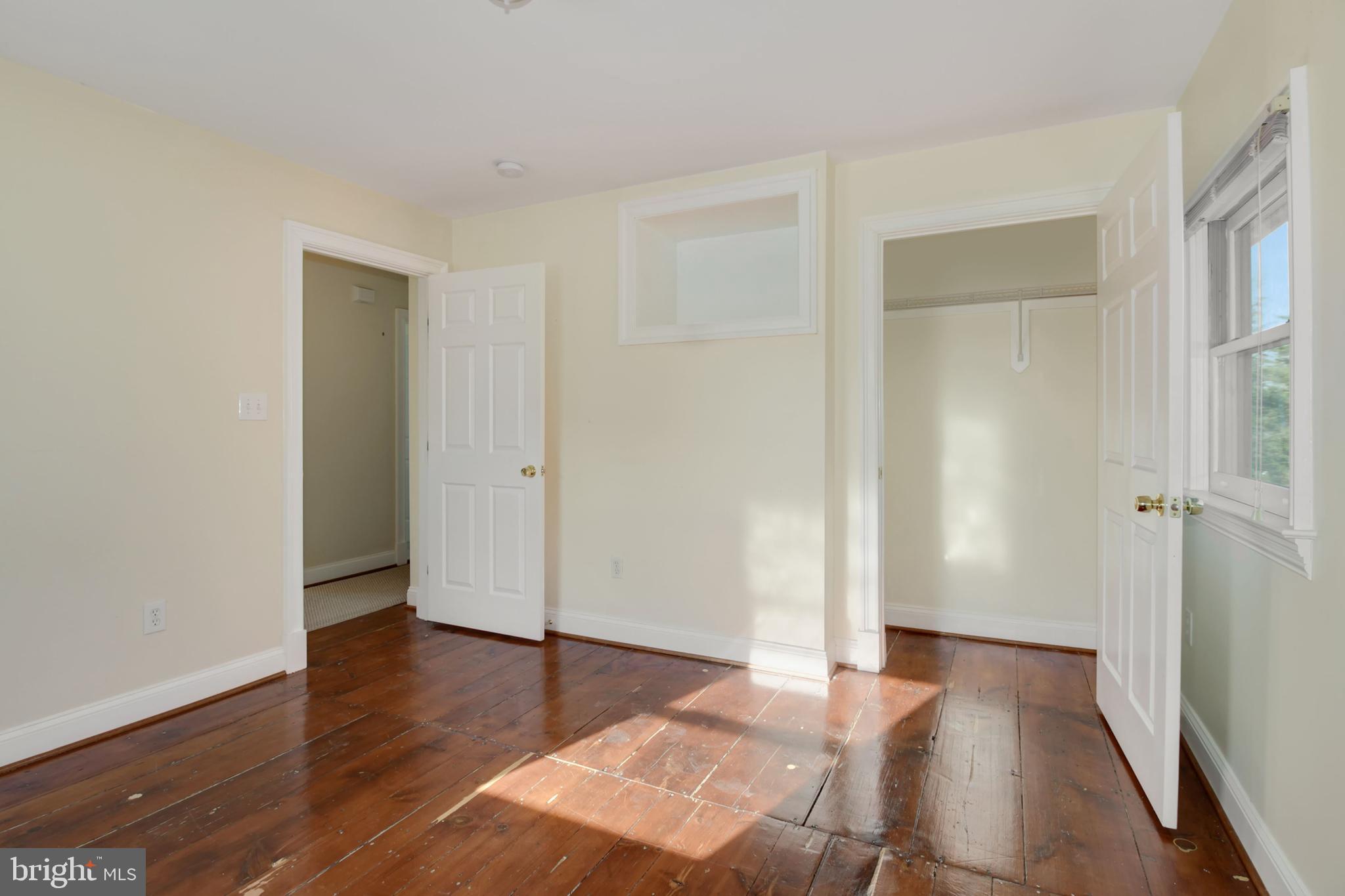 112 Main Street, Unit A New Windsor, MD 21776 - Photo 15 of 39 an empty room with wooden floor and windows