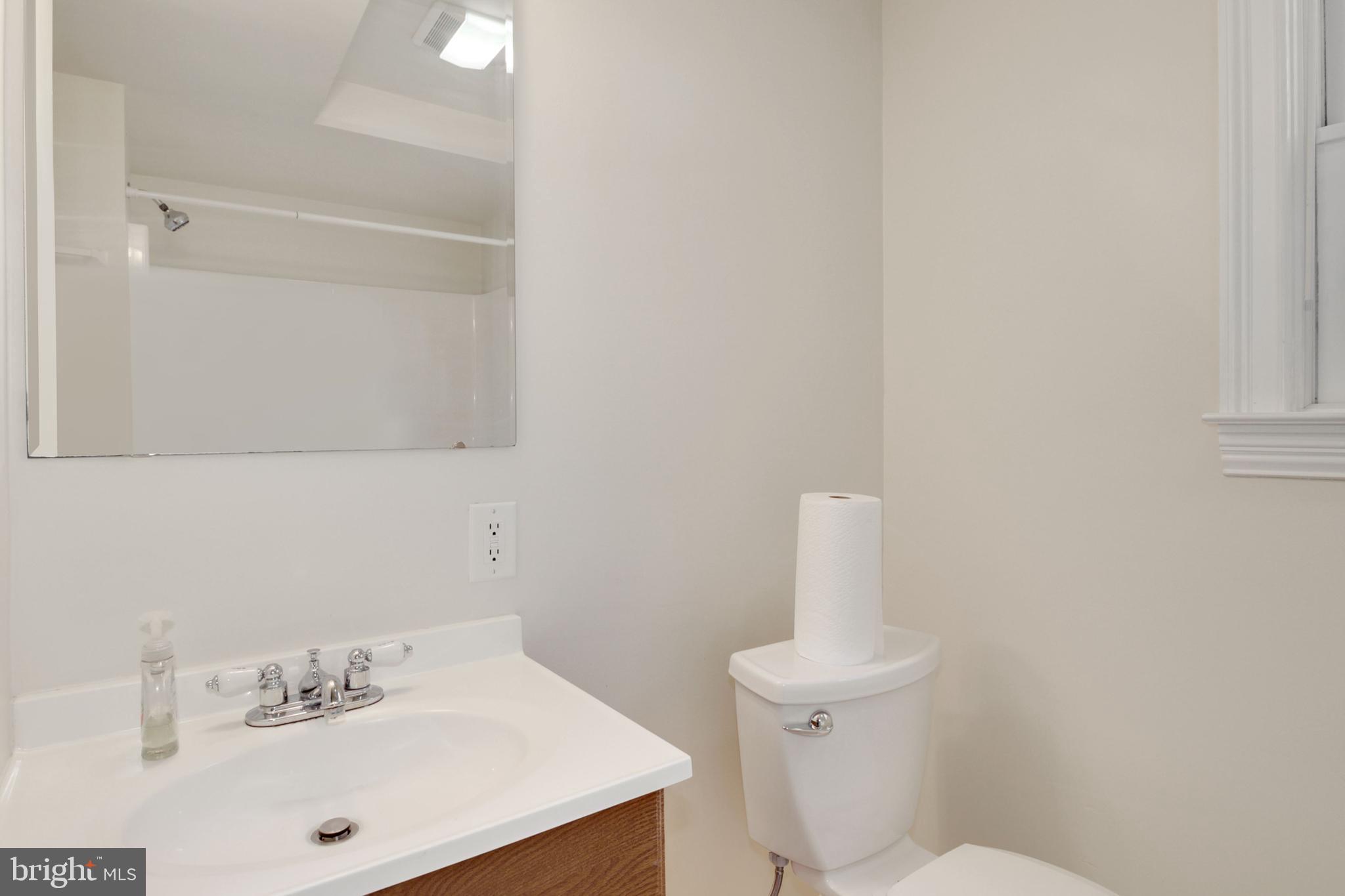 112 Main Street, Unit A New Windsor, MD 21776 - Photo 18 of 39 a bathroom with a sink a toilet and a mirror