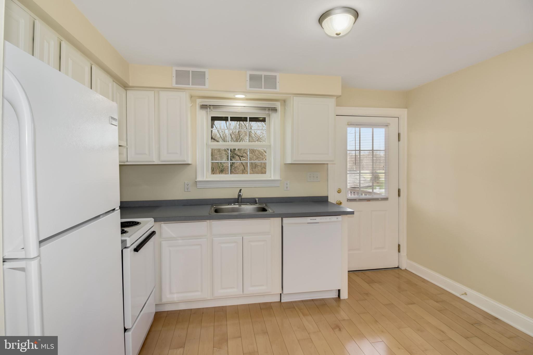 112 Main Street, Unit A New Windsor, MD 21776 - Photo 23 of 39 a kitchen with granite countertop a sink cabinets and stainless steel appliances