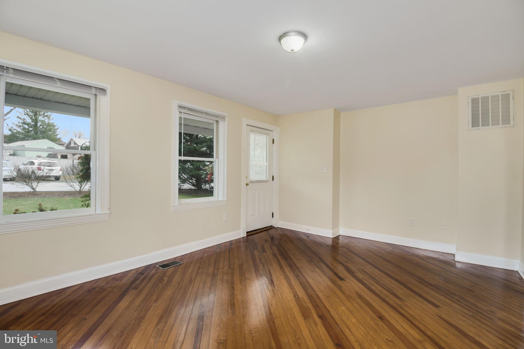 112 Main Street, Unit A New Windsor, MD 21776 - Photo 28 of 39 an empty room with wooden floor and windows