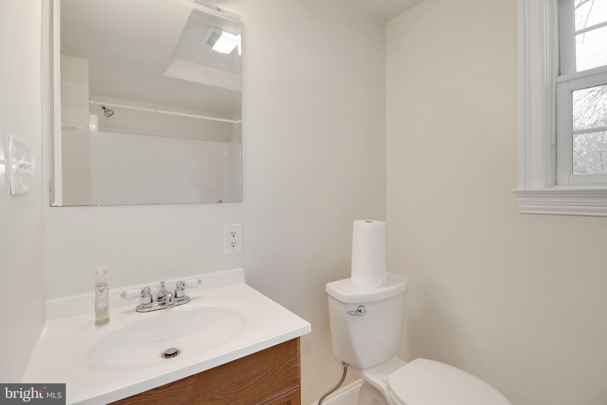 112 Main Street, Unit A New Windsor, MD 21776 - Photo 31 of 39 a bathroom with a sink mirror and toilet