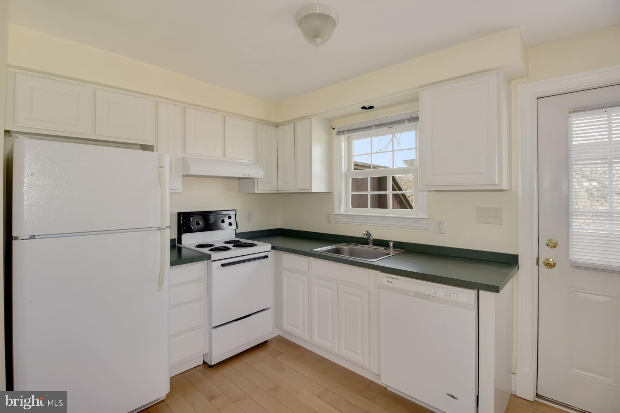 112 Main Street, Unit A New Windsor, MD 21776 - Photo 10 of 39 a kitchen with granite countertop a sink stove and refrigerator