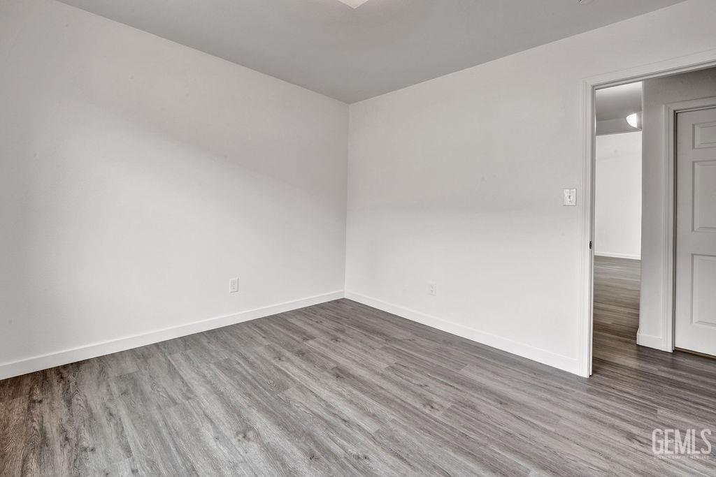 Undisclosed Address McFarland, CA 93250 - Photo 13 of 35 a view of an empty room with wooden floor and a window